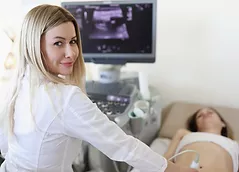 doctor-doing-ultrasound-scan-to-woman-patient-in-clinic.png
